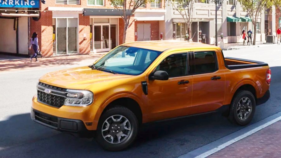 A yellow 2022 Ford Maverick small pickup truck is parked.