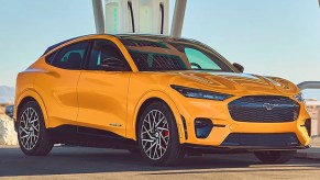 A yellow 2022 Ford Mustang Mach-E electric SUV is parked.