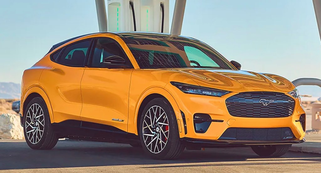 A yellow 2022 Ford Mustang Mach-E electric SUV is parked outdoors. 