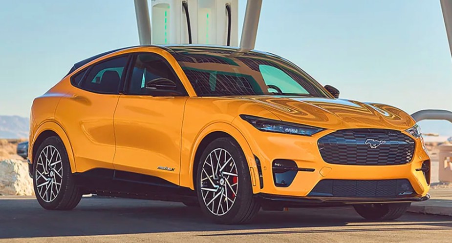 A yellow 2022 Ford Mustang Mach-E electric SUV is parked.