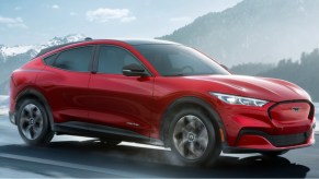 A 2022 Ford Mustang Mach-E electric SUV is driving on the road.