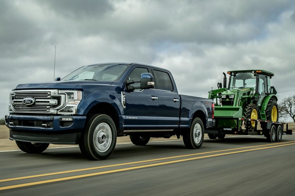 A new Ford F-350 heavy-duty truck tows a trailer behind it. 