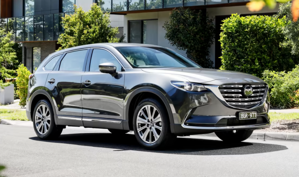 Front angle view of silver 2023 Mazda CX-90, highlighting its release date and price