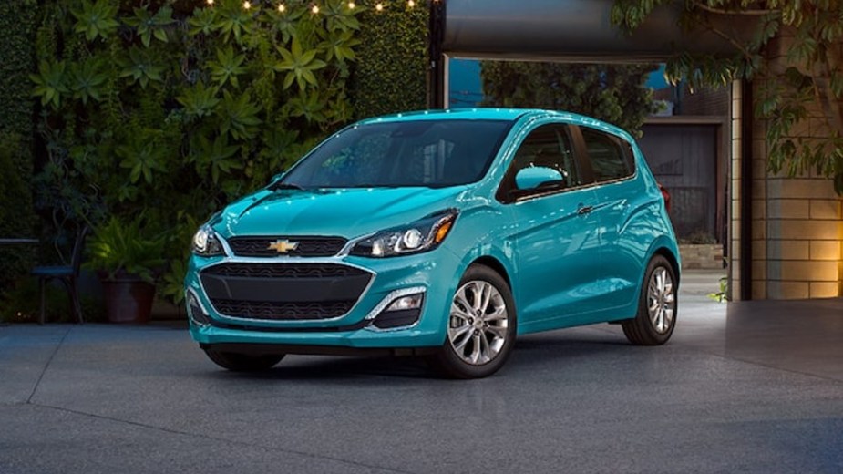 Front angle view of turquoise 2022 Chevy Spark, the only American car that costs less than $15,000.
