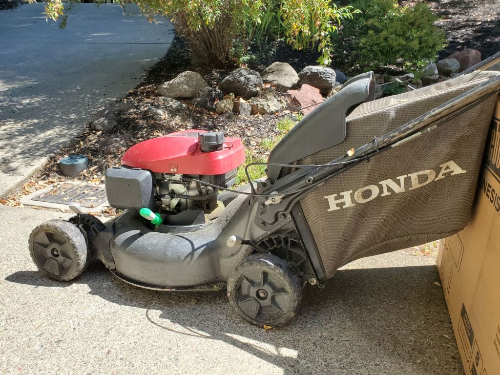 A red Honda lawn mower outdoors.