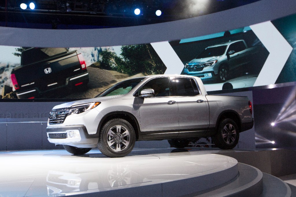A Honda Ridgeline mid-size truck sits on display at an auto show.