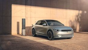 A Hyundai Ioniq 5 all-electric SUV (EV) plugged into a charging station