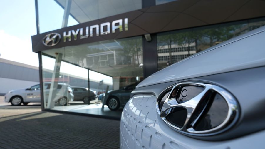 The outside of a Hyundai dealership with a close up of a white Hyundai vehicle.