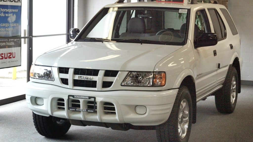 a white isuzu rodeo parked in a dealership show room
