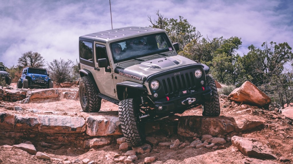 Gray two-door Jeep Rubicon navigating a rock-crawling trail.