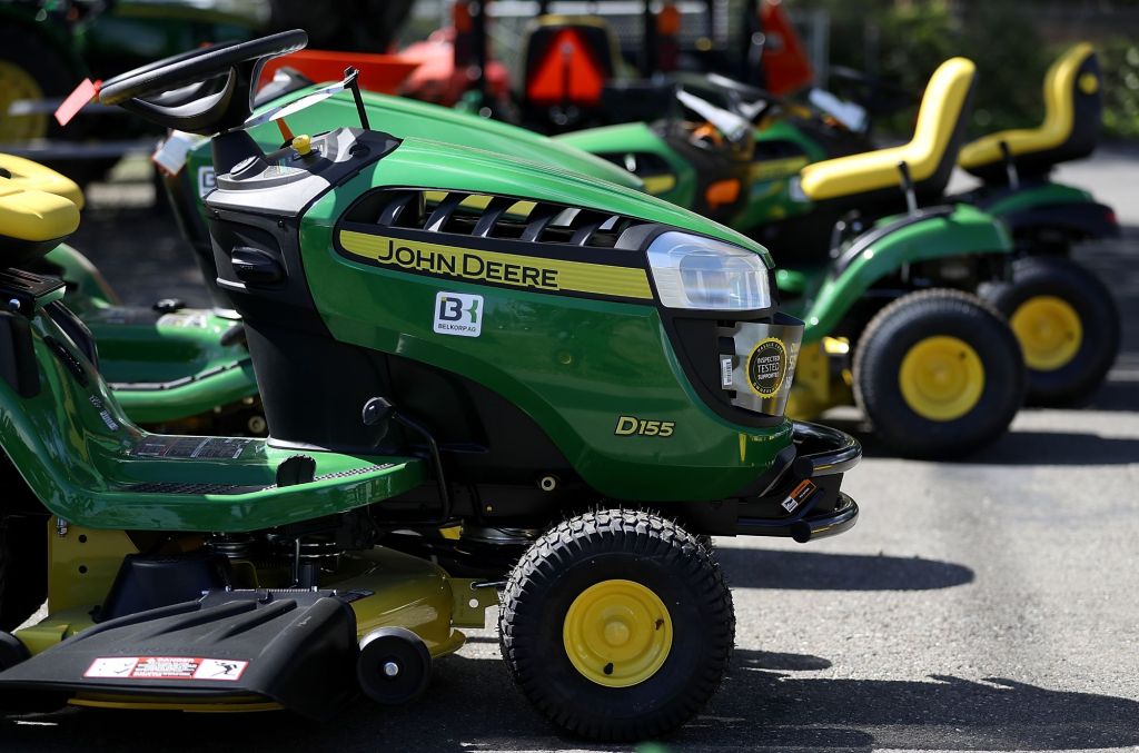 A green John Deere Riding Mower with others behind it.