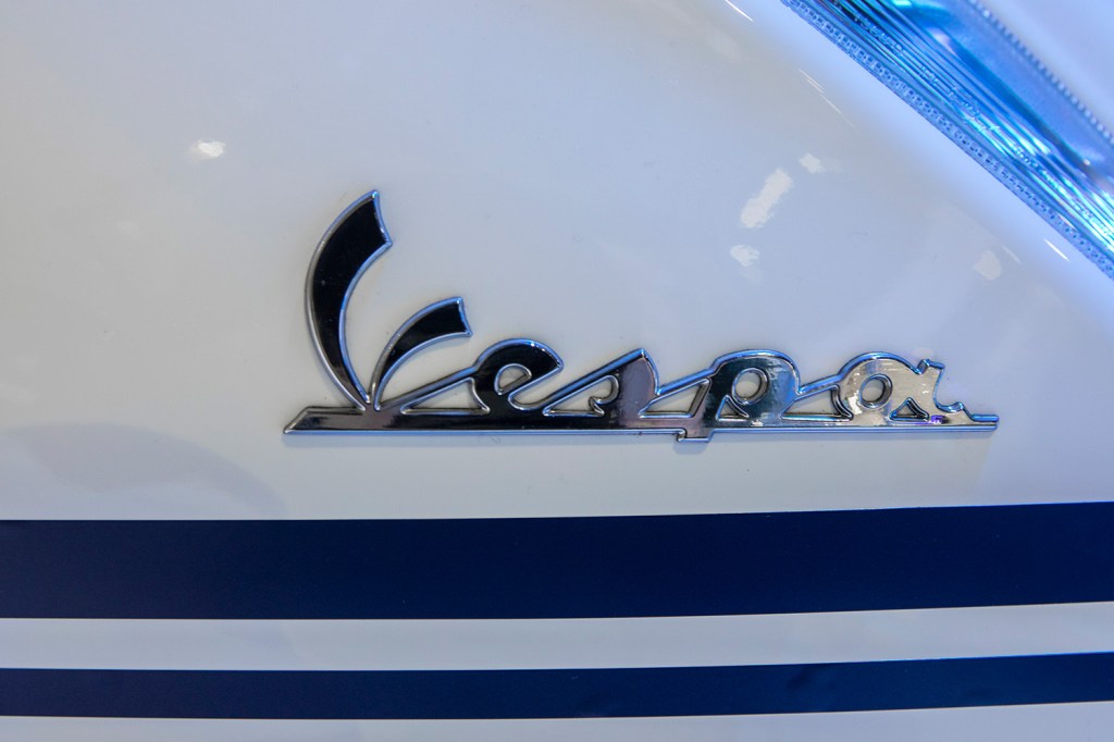 closeup of white Vespa sprint logo much like the model Justin Bieber collaborated on
