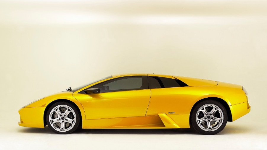 A yellow 2003 Lamborghini Murcielago shows off its side profile.