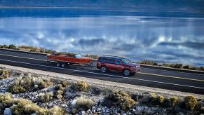 Maroon 2022 Jeep Wagoneer, the only SUV that can tow 10,000 pounds, towing a boat