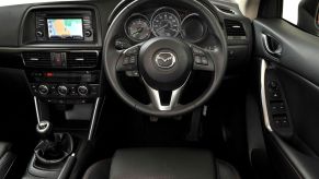 A Mazda's interior with knobs and buttons.