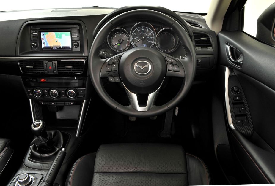 A Mazda's interior with buttons and knobs instead of touchscreens.  