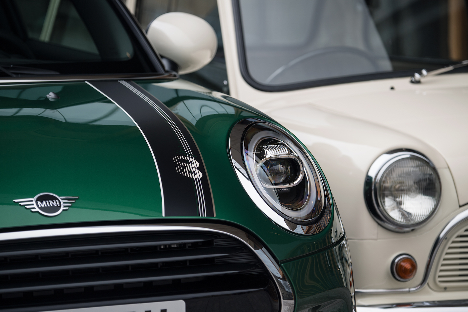 A green new Mini Cooper and a classic Morris Mini-Minor.