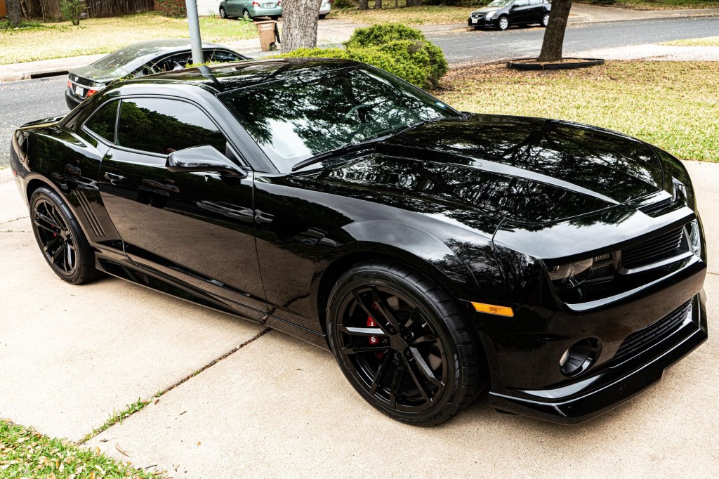 Black modified 2010 Chevrolet Camaro SS in the driveway