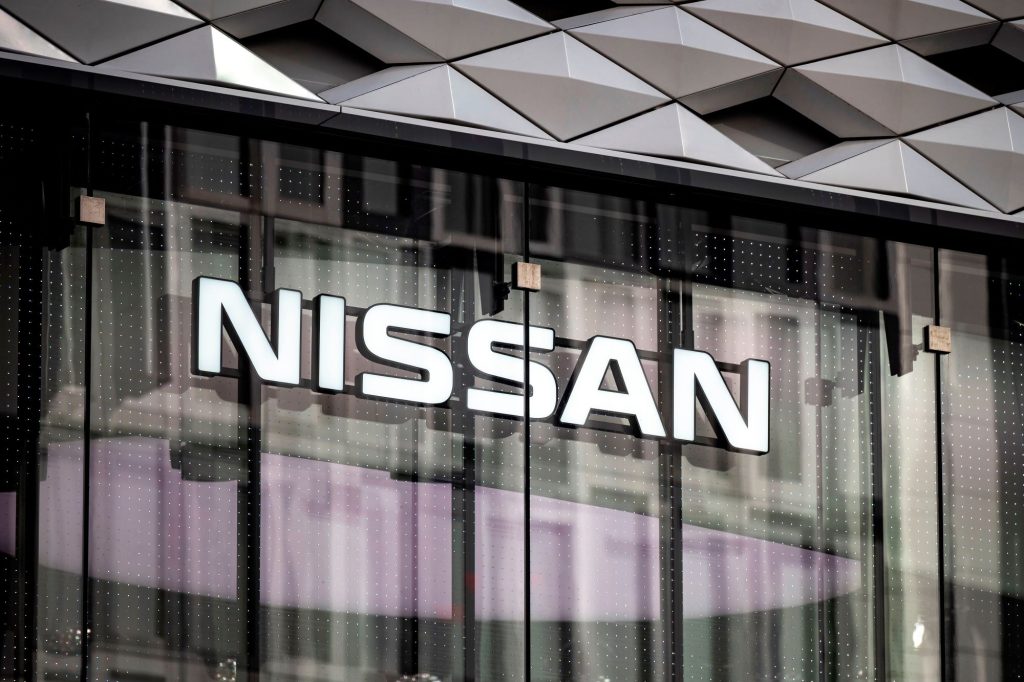 A building with high glass doors and Nissan, which provides the best smell of new cars, is written on the side. 