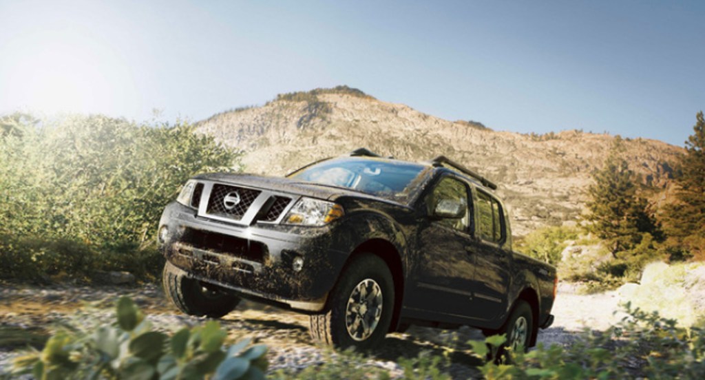 A gray 2017 Nissan Frontier small pickup truck is off-roading. 