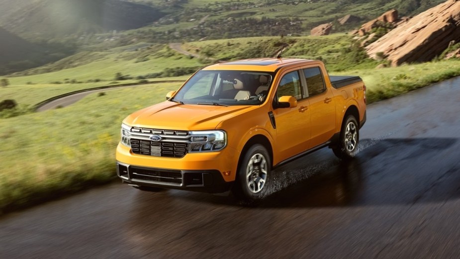 Orange 2022 Ford Maverick, the only pickup truck that costs less than $20,000, driving on a mountain road