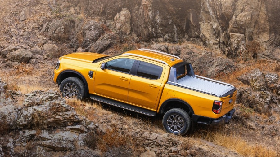 Orange 2023 Ford Ranger driving on a mountain road, highlighting how Ford Ranger EV could be the best electric truck