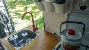 An RV camper van kitchen unit with a USSR style kettle in Oslonino, Poland