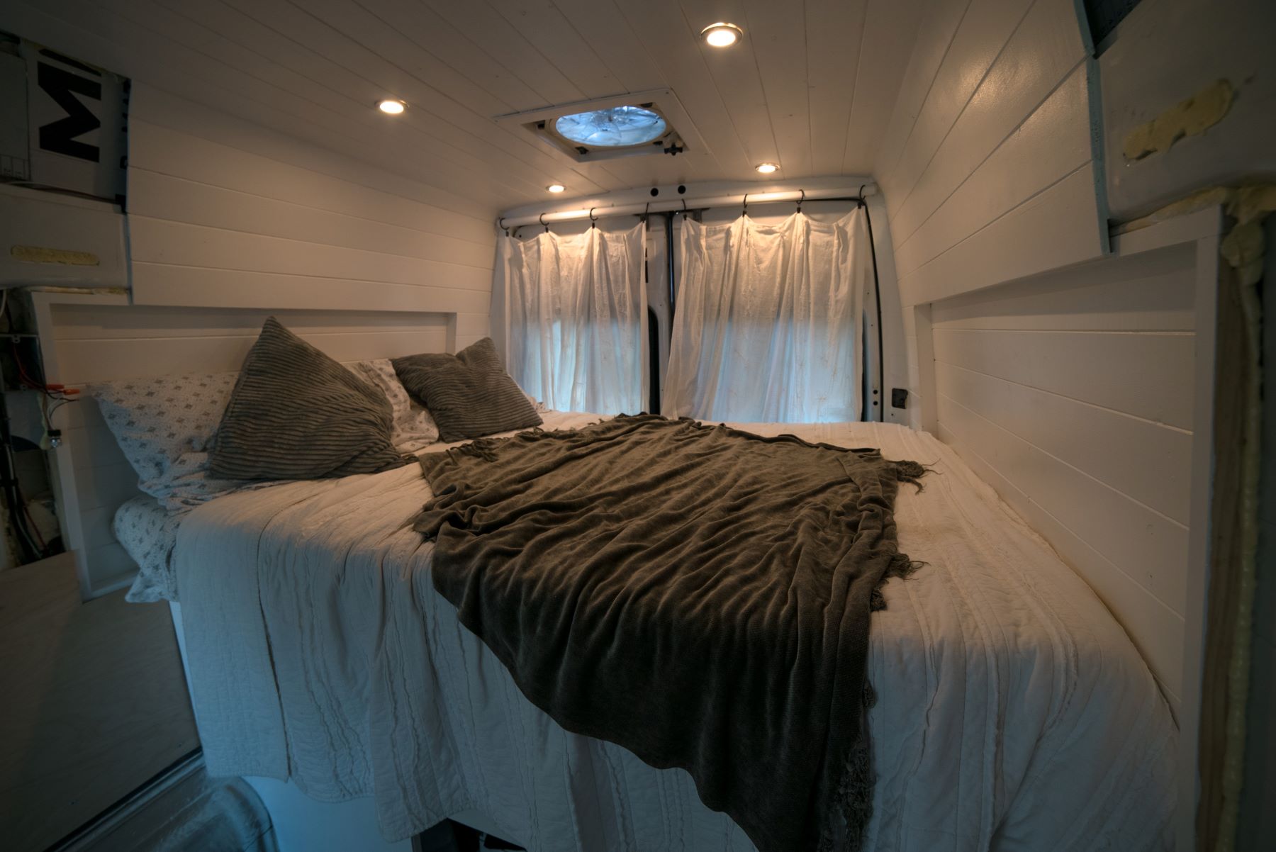 The bedroom of a Freightliner Sprinter High Top van as one RV mattress option