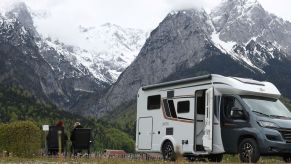 An RV nestled in the mountains that have multi-use items.