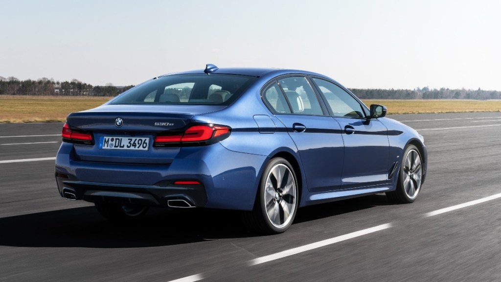 Rear angle view of blue 2023 BMW 5 Series, highlighting its release date and price