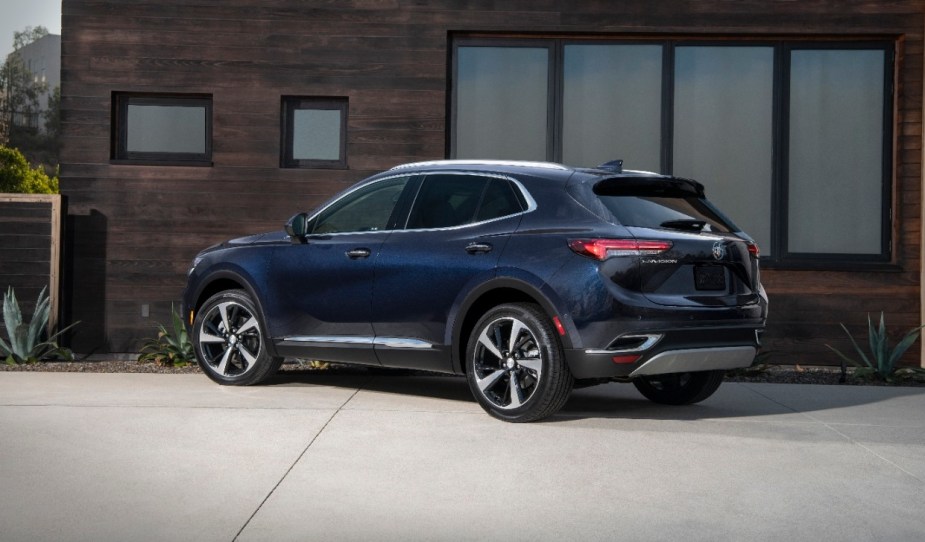 Rear angle view of dark blue 2023 Buick Envision, highlighting its release date and price