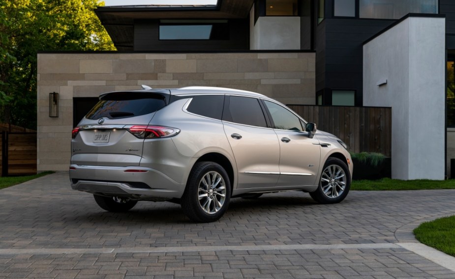 Rear angle view of silver 2023 Buick Enclave Premium, a seven-seat luxury SUV. 