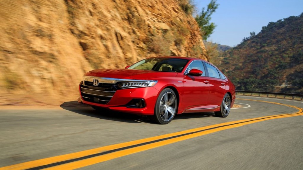 Red 2022 Honda Accord driving on a curvy road