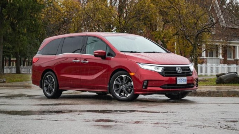 A red 2022 Honda Odyssey minivan is parked. 
