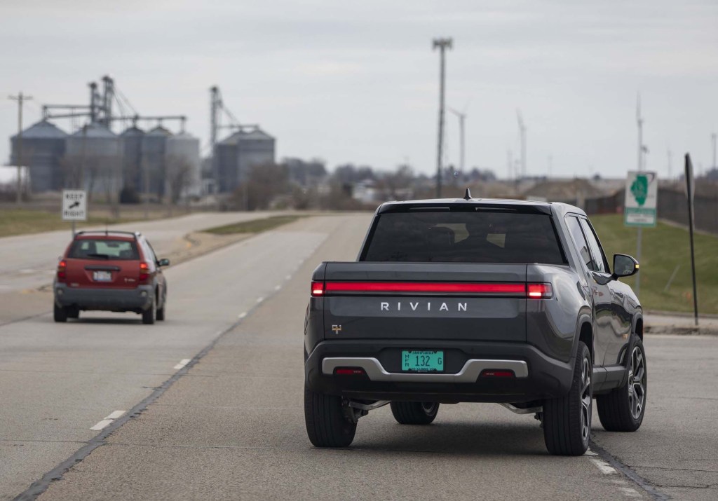 A Canyon Red 2022 Rivian R1T Launch Edition is parked.