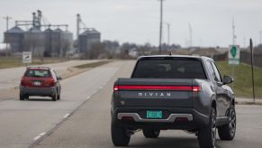 Rivian R1T, potentially a Rivian R1T exterior issues, driving down the road.