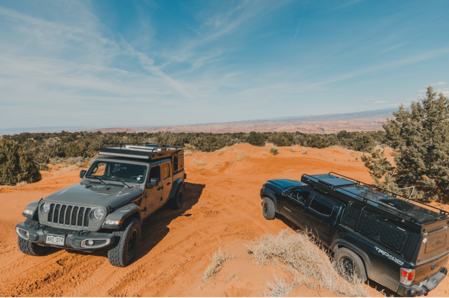 Rossmonster campers parked in the desert. One is mounted to a Jeep Gladiator and the other on a Toyota Tacoma