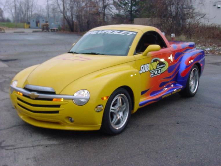 A yellowish Chevy SSR Pace truck