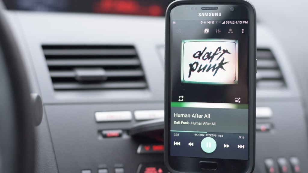 a daft punk song playing on a Samsung phone that is mounted in the cd player 