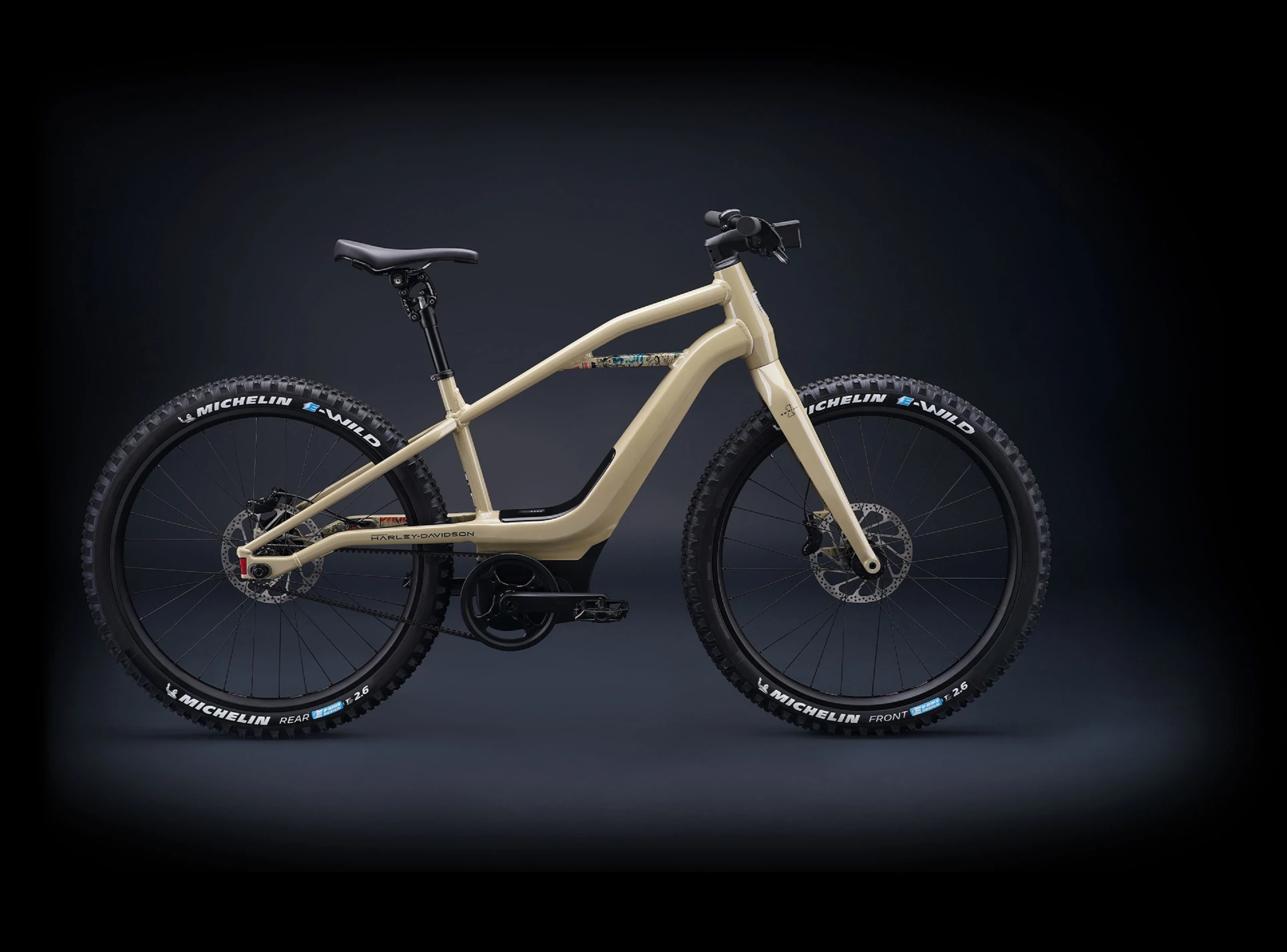 The side view of a tan Serial 1 BASH/MTN electric mountain bike in a black studio