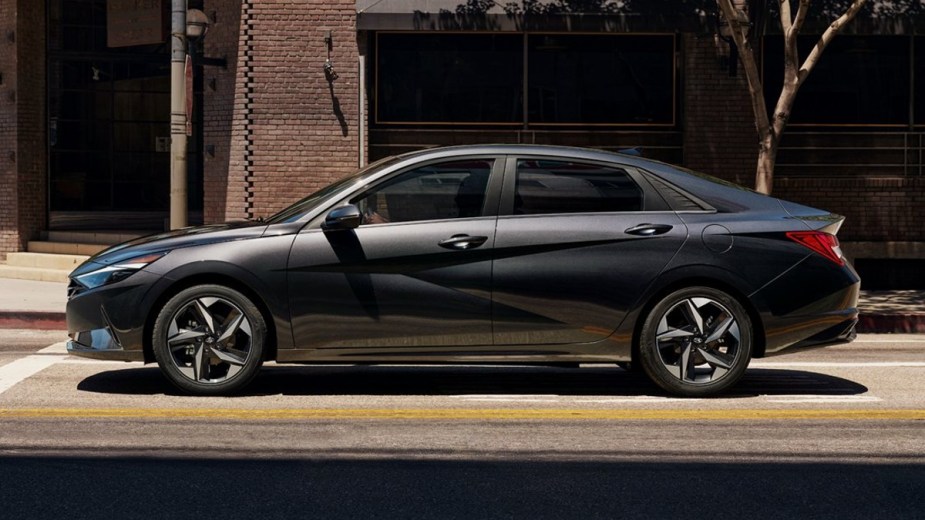 Side view of dark gray 2022 Hyundai Elantra, a non-hybrid gas-powered car with money-saving high fuel economy