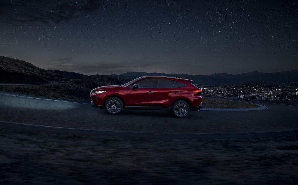 Side view of red 2023 Toyota Venza, highlighting its release date and price