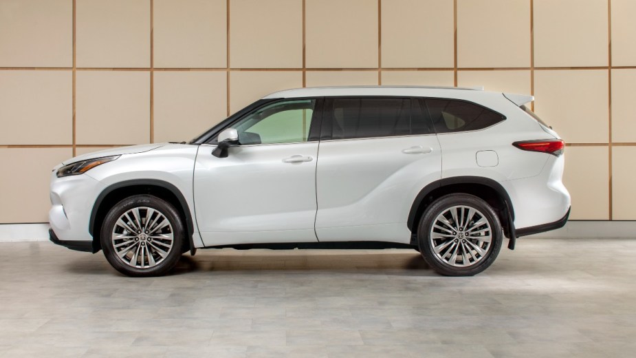 Side view of white 2023 Toyota Highlander, highlighting its release date and price
