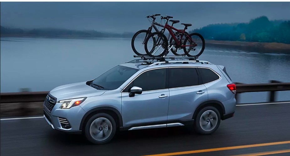 A gray 2022 Subaru Forester is driving on the road. 