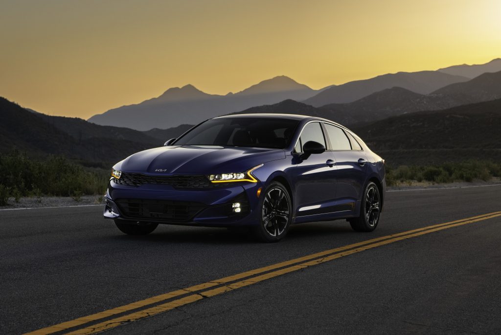 A blue 2022 Kia K5 GT on a desert mountain road