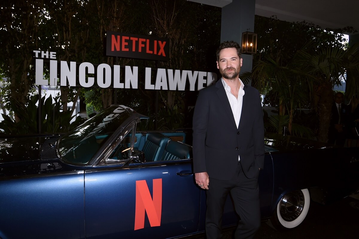 Manuel Garcia-Rulfo poses with a Netflix Lincoln Continental.