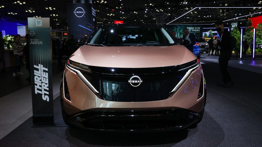 The front view of a pink electric 2023 Nissan Ariya at the 2022 New York Auto Show