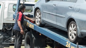 Car being loaded on a tow truck. is there a way you can stop your car from being towed?