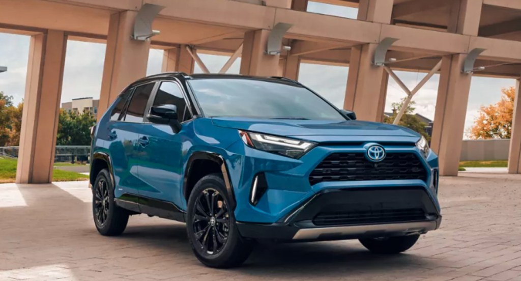 A blue 2022 Toyota RAV4 Hybrid small SUV is parked outdoors. 