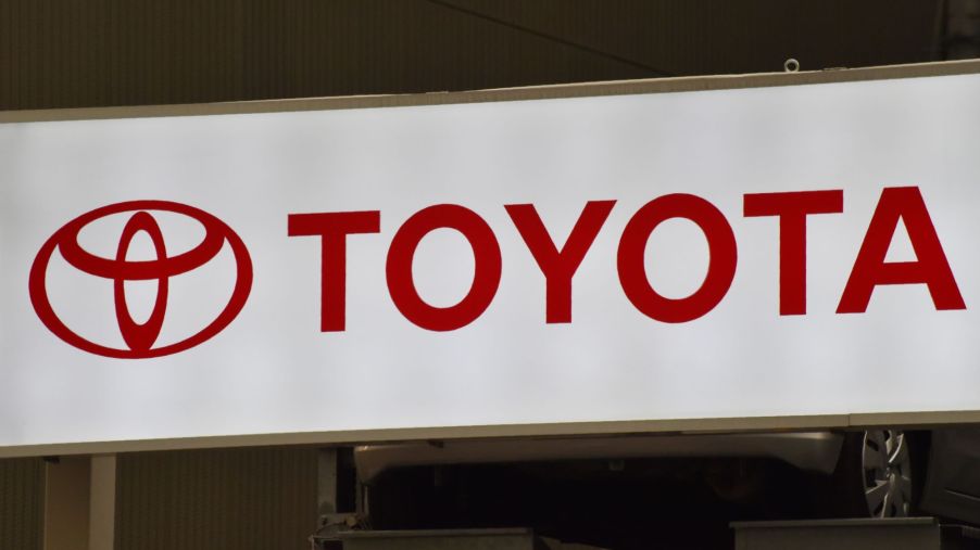 A white Toyota sign with Toyota written in red.